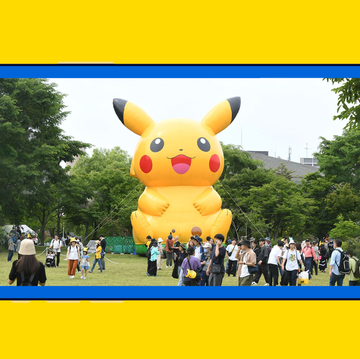 large pikachu balloon at a festival surrounded by a crowd large pikachu balloon at a festival surrounded by a crowd