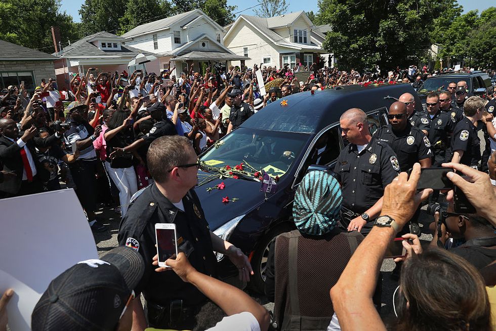 fans tossing flowers on the hearse carrying muhammad ali's body