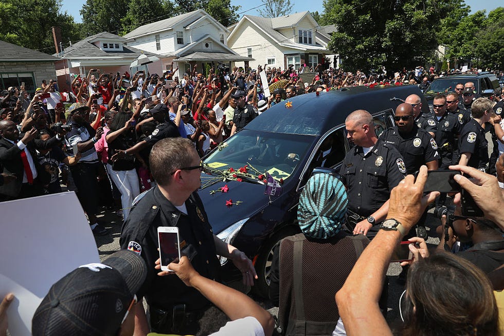 Muhammad Ali funeral procession in Louisville, Kentucky fans tossing flowers on the hearse carrying muhammad ali's body