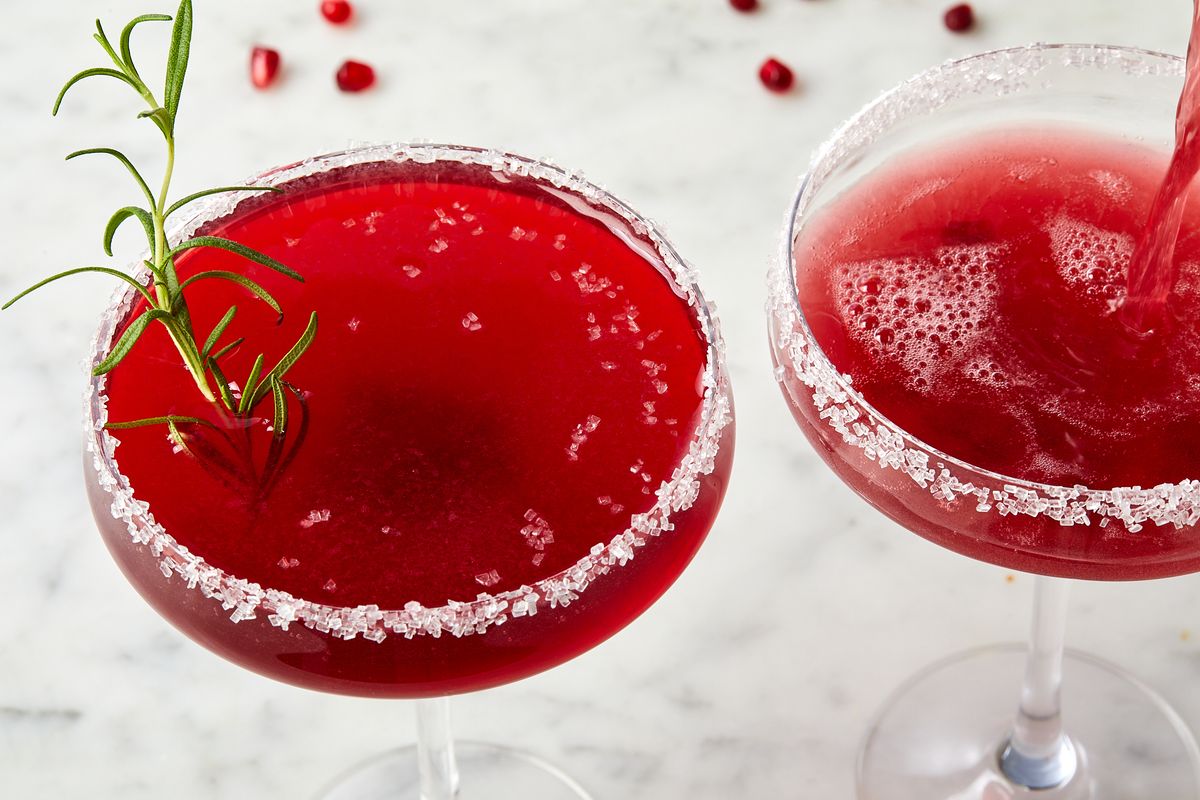 pomegranate martini in a glass with a sanding sugar rim