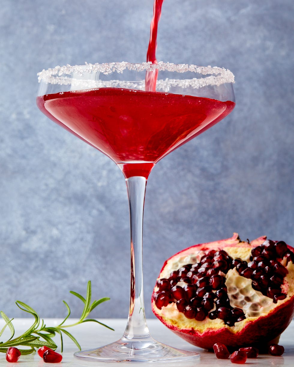 pomegranate martini in a glass with a sanding sugar rim