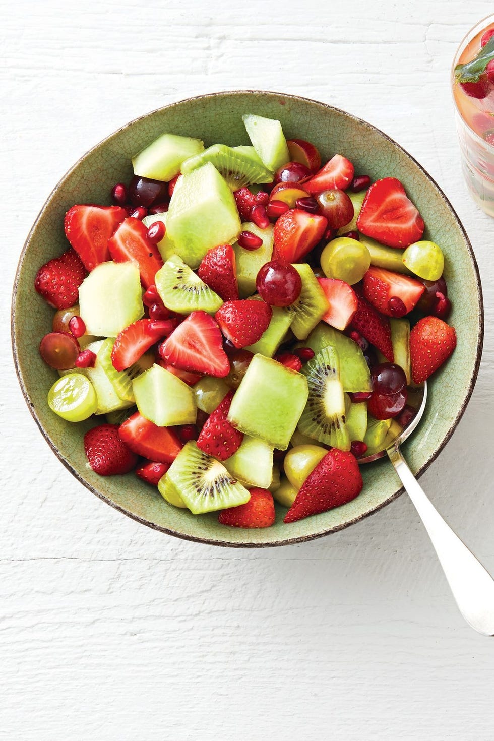 red and green fruit salad with mint syrup and pomegranate