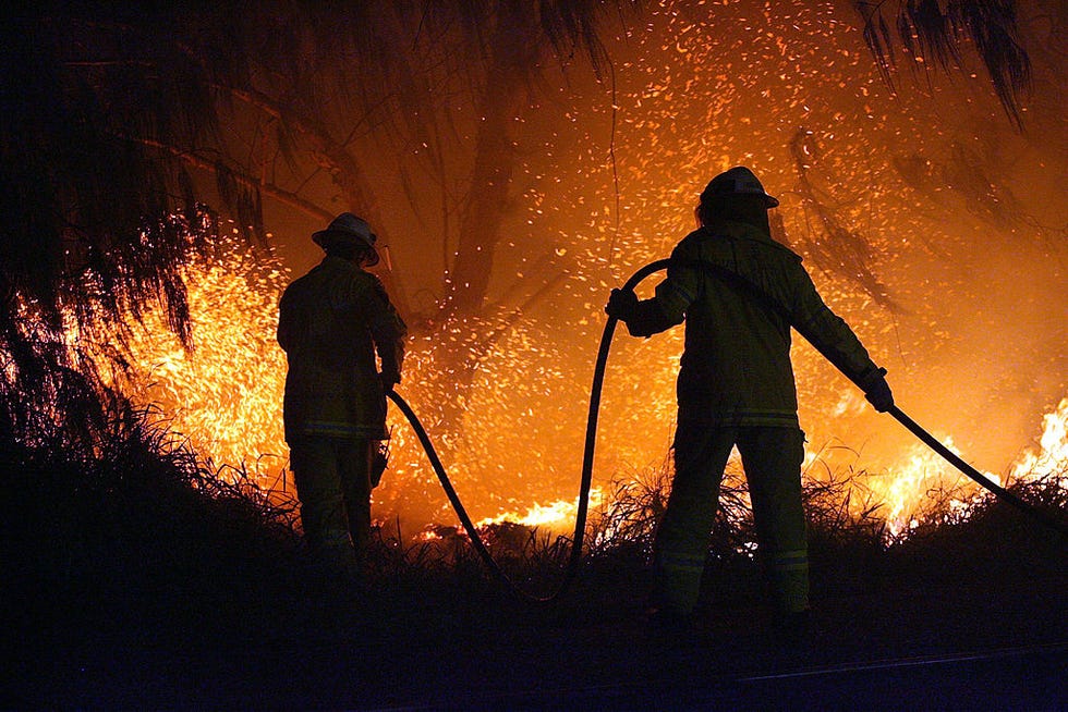 gold coast, australia   february 11 firemen attempt to put out a fire outside of the gold coast stop of the 2007 good vibrations festival at doug jennings park on february 11, 2007 in the gold coast, australia good vibrations is an annual music festival staged at various australian cities within natural surroundings as the backdrop for proceedings  photo by bradley kanarisgetty images