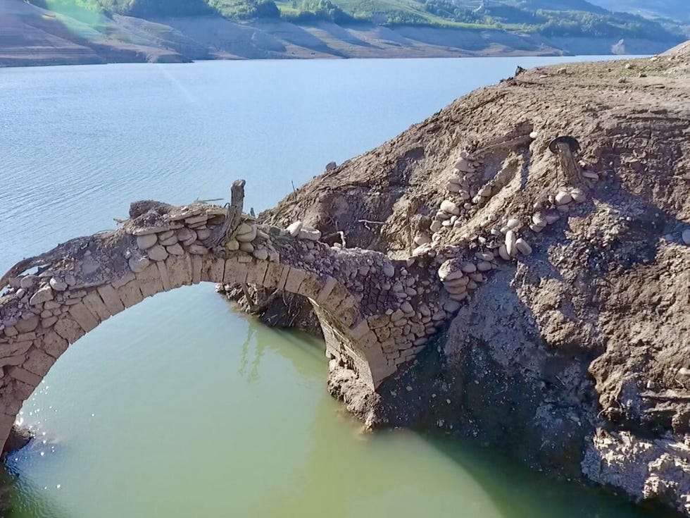collapsed stone arch bridge over water