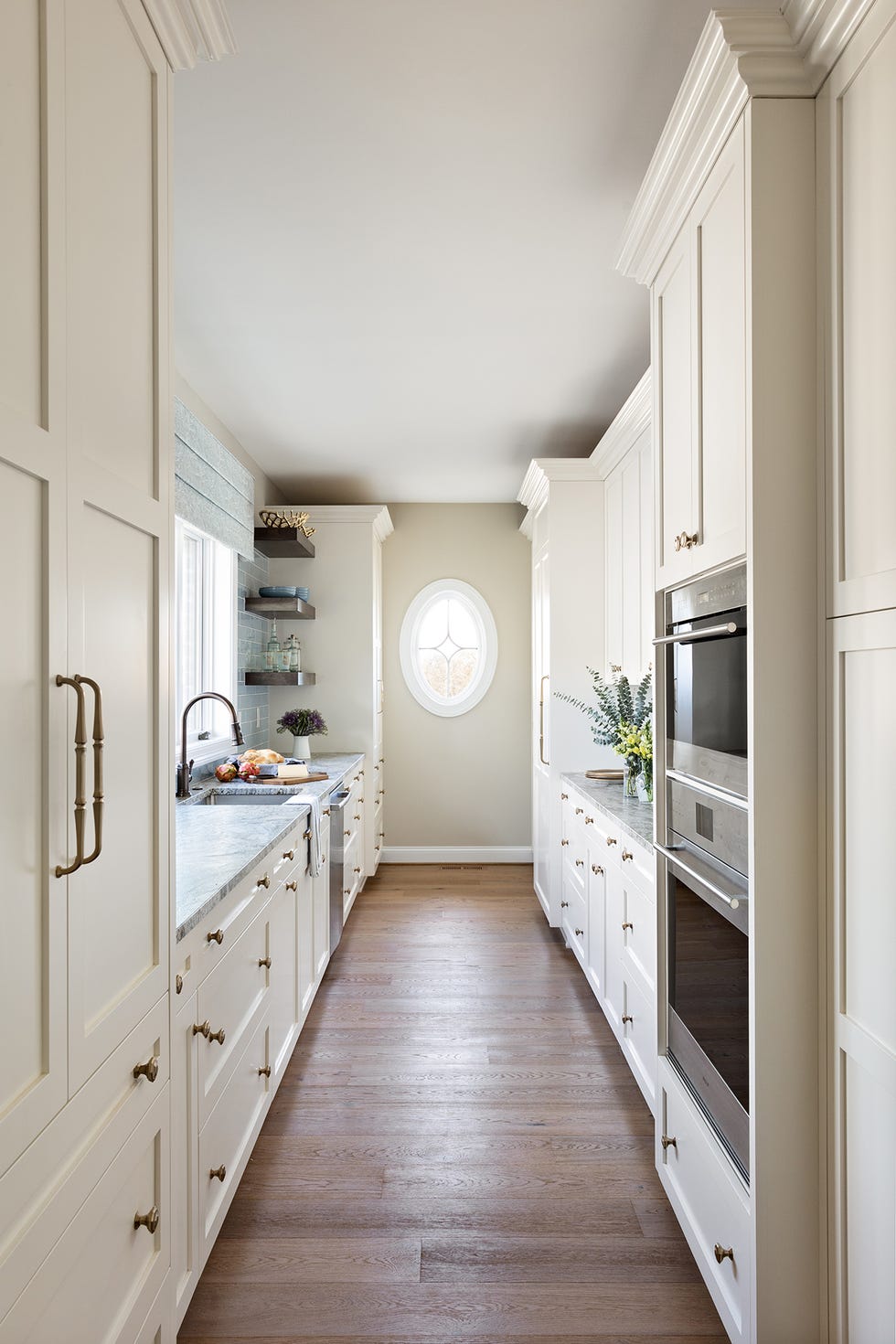 modern kitchen with a central aisle featuring cabinets a countertop and appliances