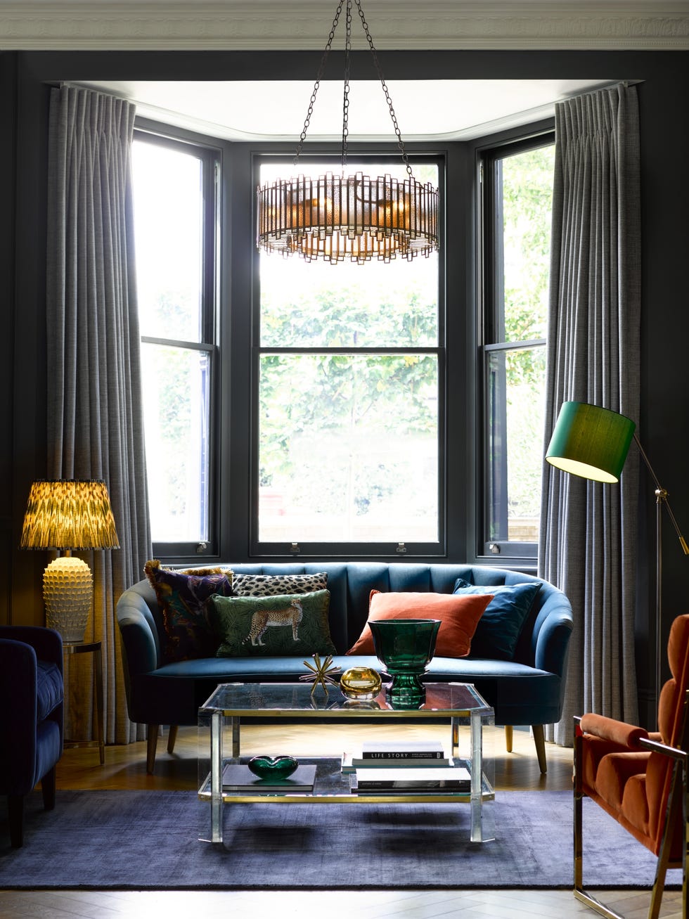 dark living room with blue sofa and pendant light