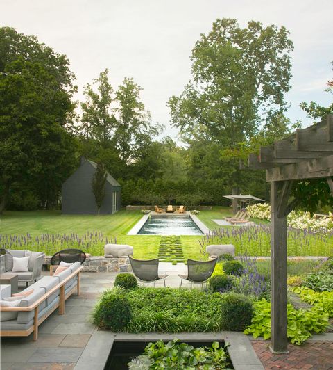 backyard patio with pool and lawn in the background