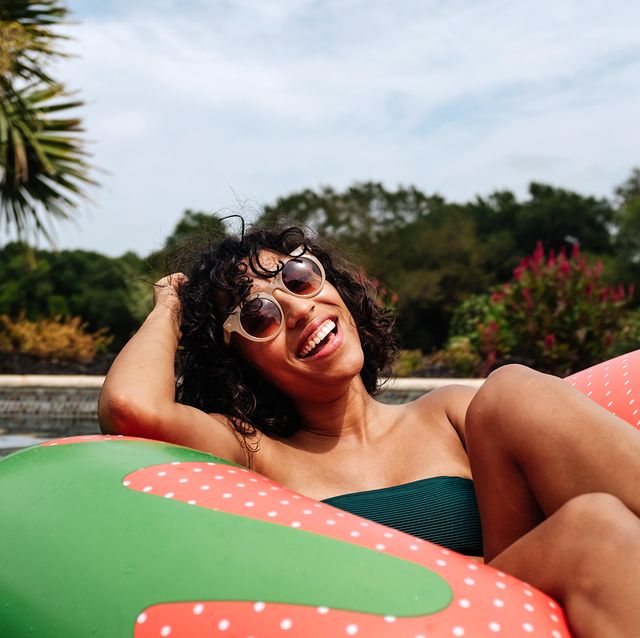 woman floating in strawberry pool float