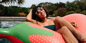 woman floating in strawberry pool float