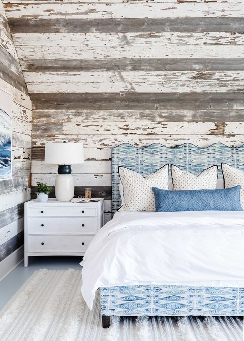 bedroom, wooden wall panelling, blue and white bed frame with white linen sheets