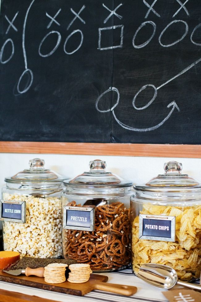 self serve snack bar with kettle corn, pretzels and potato chips in glass jars