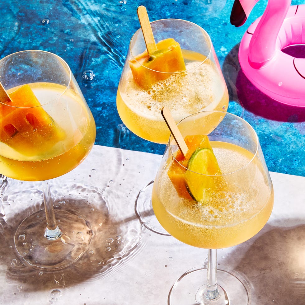 spritz with orange popsicles in them by a pool