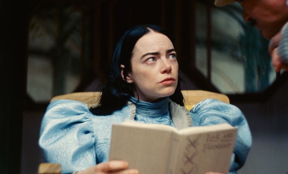 emma stone reading a book in poor things