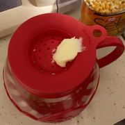 red plastic and glass microwavable popcorn maker