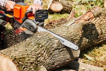 chainsaw cutting through a log