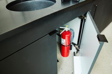 a fire extinguisher under a sink