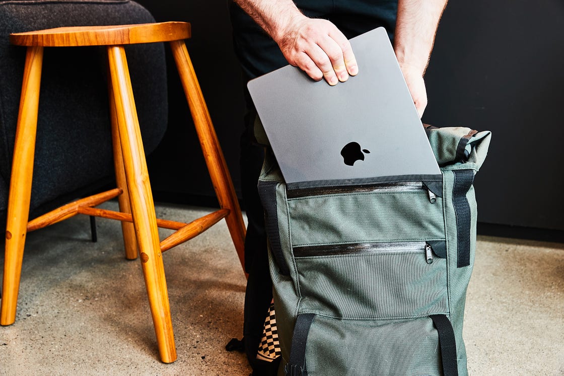 a person holding a laptop