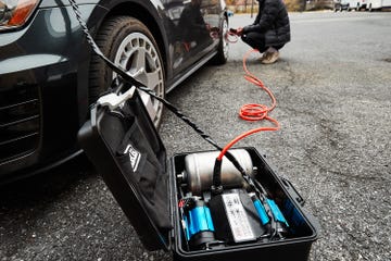 air compressor connected to a car tire