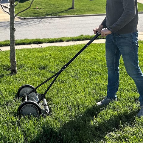 a person pushing a lawn mower