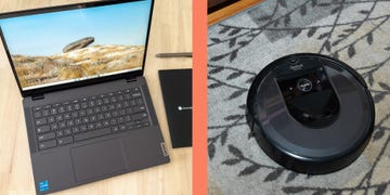 a laptop next to a robotic vacuum cleaner on the floor