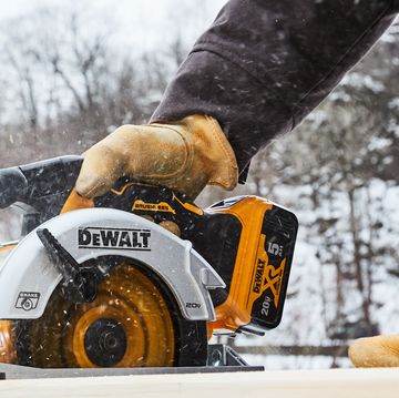 a person using a power saw in the cold