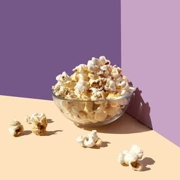 popcorn bowl on the purple beige background frontal view