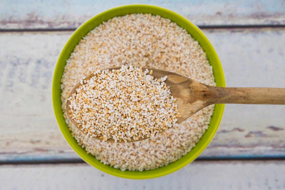 popped organic amarant on wood spoon and in bowl