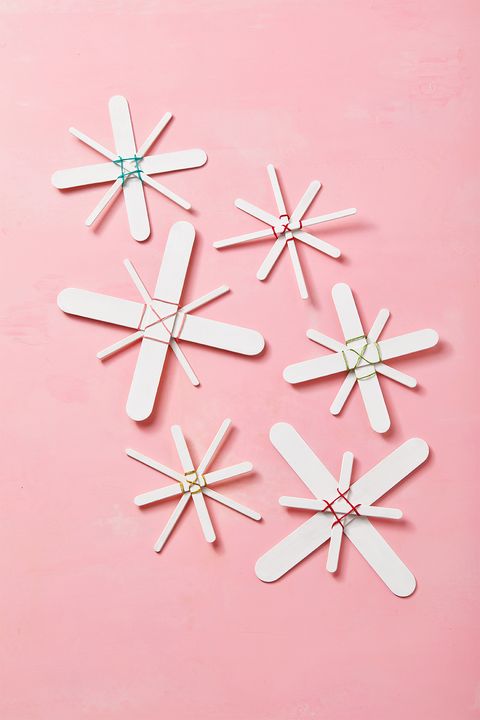 diy christmas ornaments, popsicle stick snowflakes against pick background