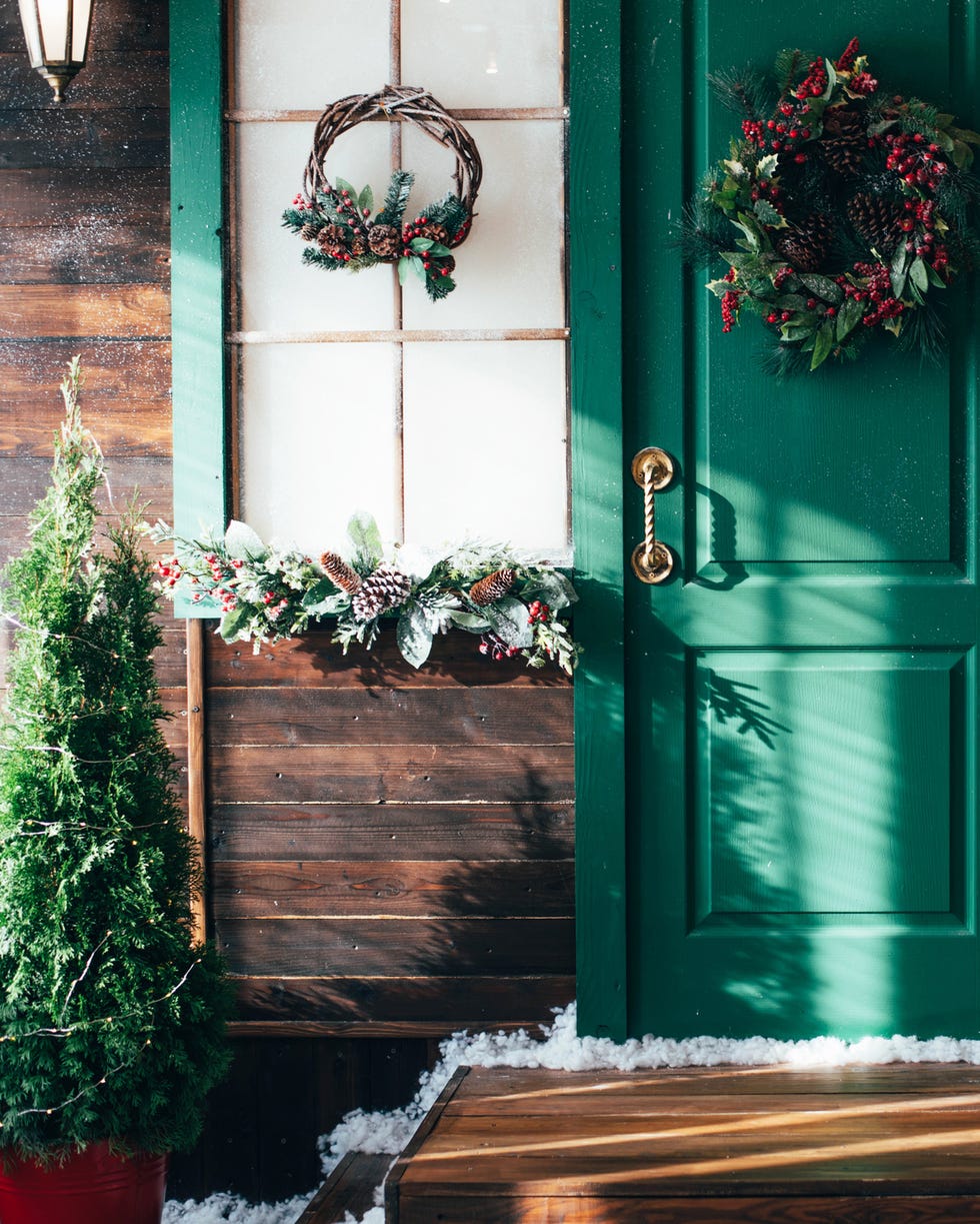 Porch with wooden door porch with wooden green door and a threshold with christmas decor