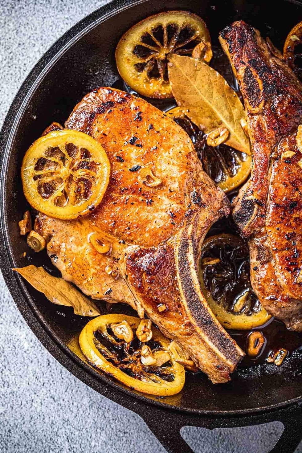 https://hips.hearstapps.com/hmg-prod/images/pork-chop-recipes-pork-chops-with-bay-leaf-and-lemon-646e862a4b9ae.jpeg?crop=1.00xw:0.834xh;0,0.0375xh&resize=980:*