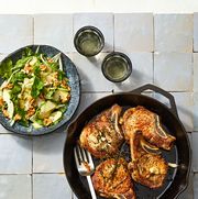 pork chops and pear salad on a tile background