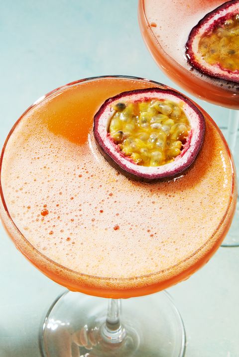 orange passion fruit martini garnished with a passionfruit