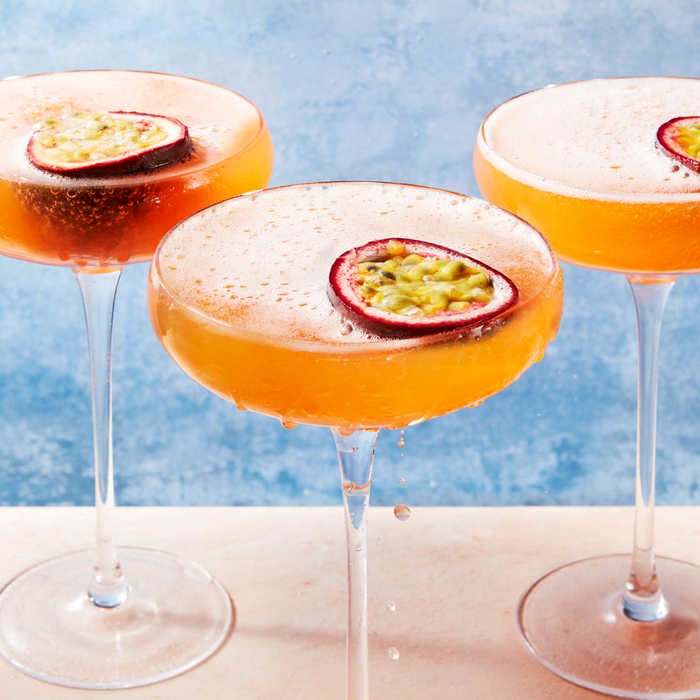orange passion fruit martini garnished with a passionfruit
