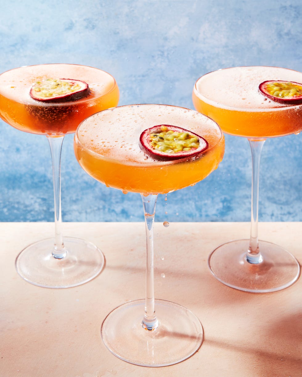 orange passion fruit martini garnished with a passionfruit