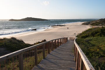 a wooden walkway to a beach