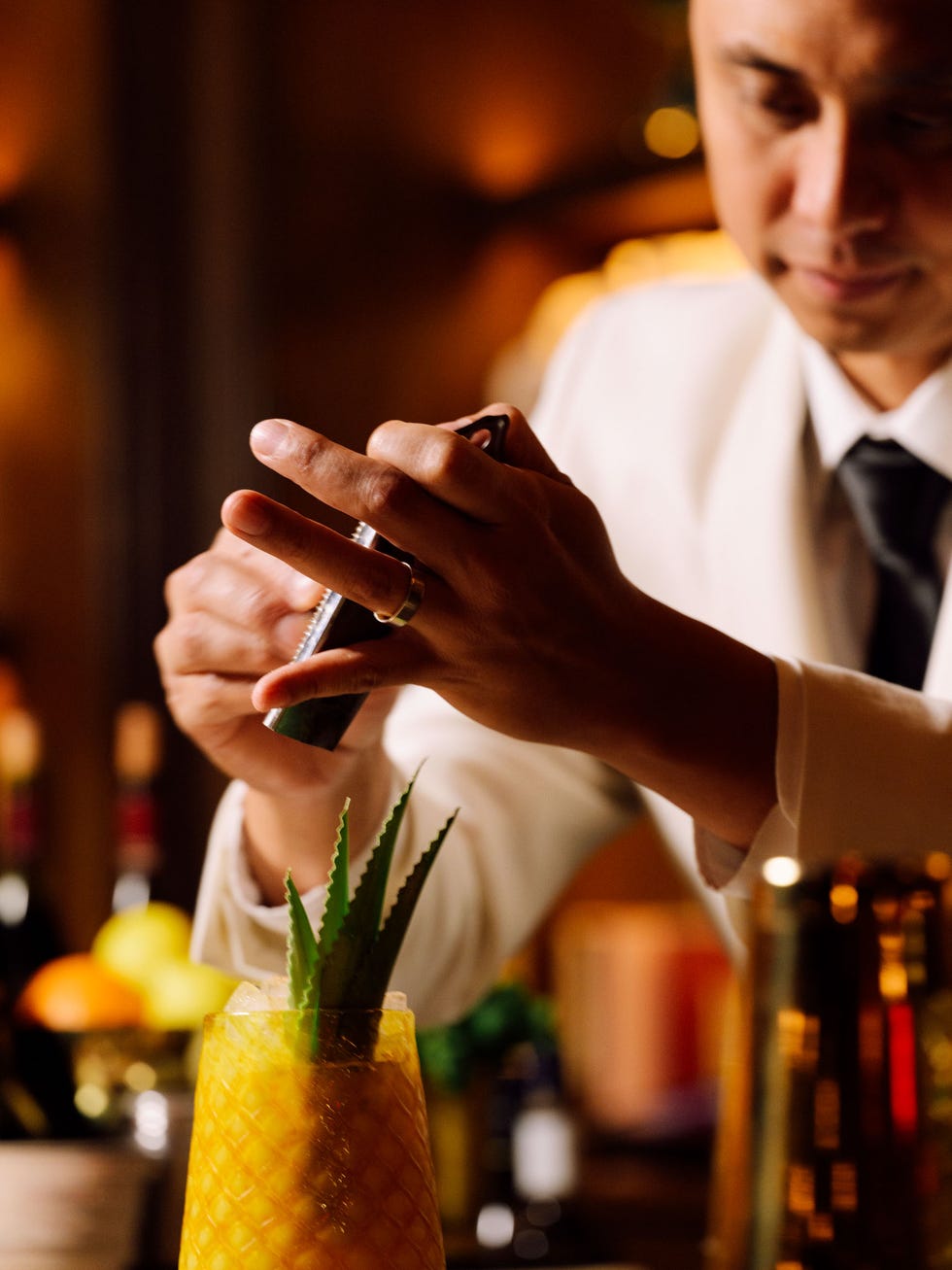 a person holding a glass of liquid