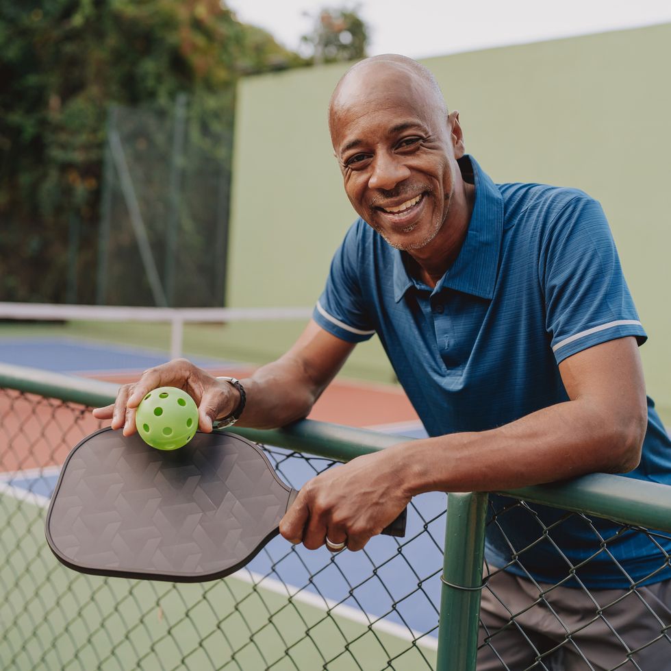 man pauses pickleball game