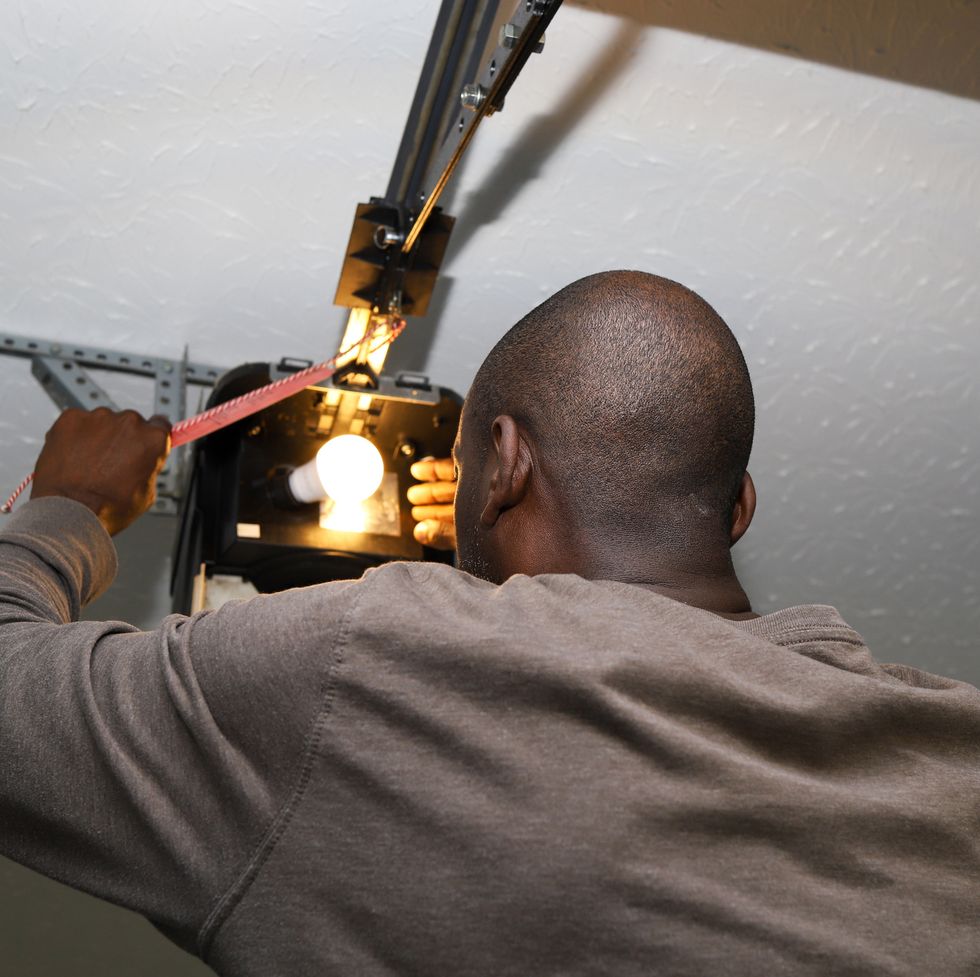 man installing a garage door opener