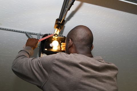 man installing a garage door opener