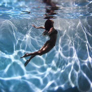 portrait of a female model underwater in a swimming pool with a in san diego, california