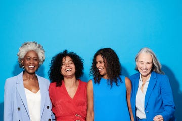 portrait of a group of mature women against a blue background