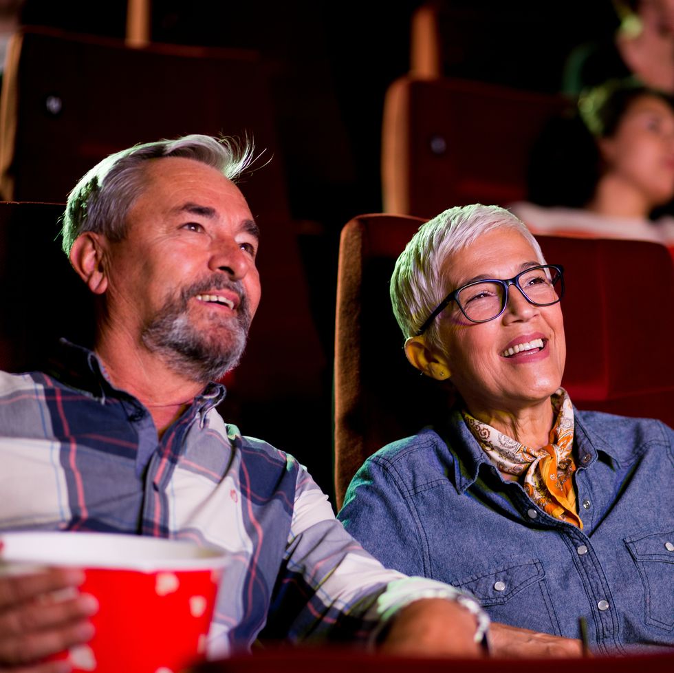 portrait of a happy senior couple watching a relaxing movie at the cinema