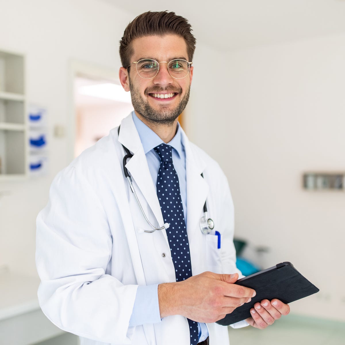 portrait of a happy young doctor in his clinic