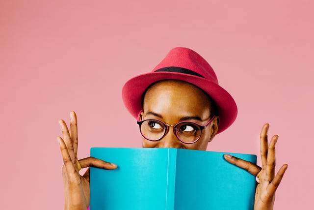 the reader portrait of a happy young woman full of joy holding a book
