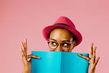 the reader portrait of a happy young woman full of joy holding a book