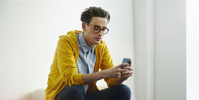 Portrait of a man using his mobile phone.