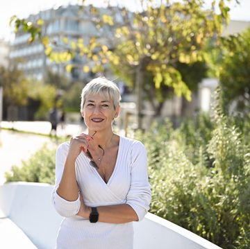 portrait of a mature woman with gray hair looking at camera.