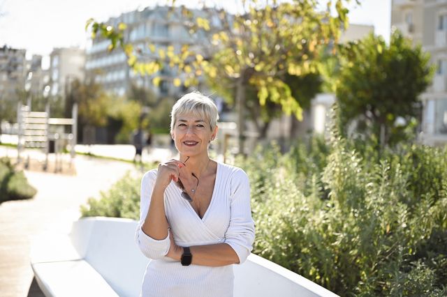 portrait of a mature woman with gray hair looking at camera.