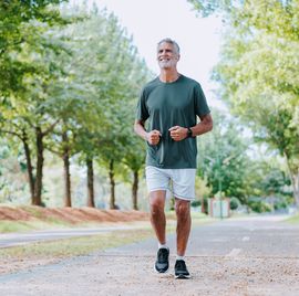 portrait of a senior man running in the public park