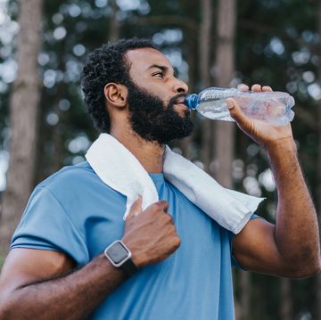 portrait of a sporty man drinking water